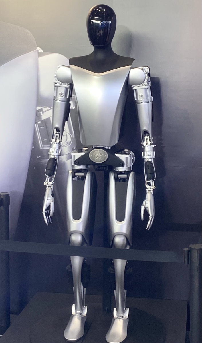 Tesla Optimus humanoid on display — AI5 is the single chip targeted at cars, Optimus, and Dojo alike